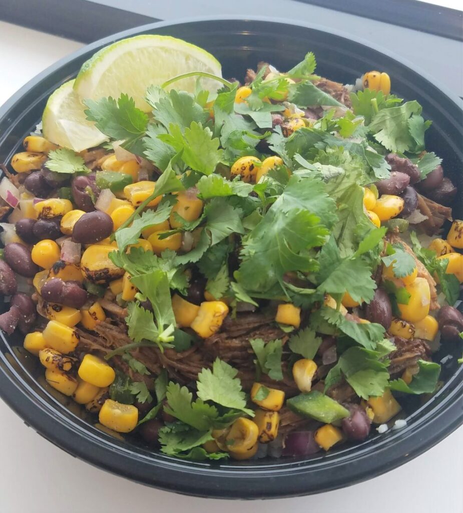 Shredded beef burrito bowl with corn and black bean salsa