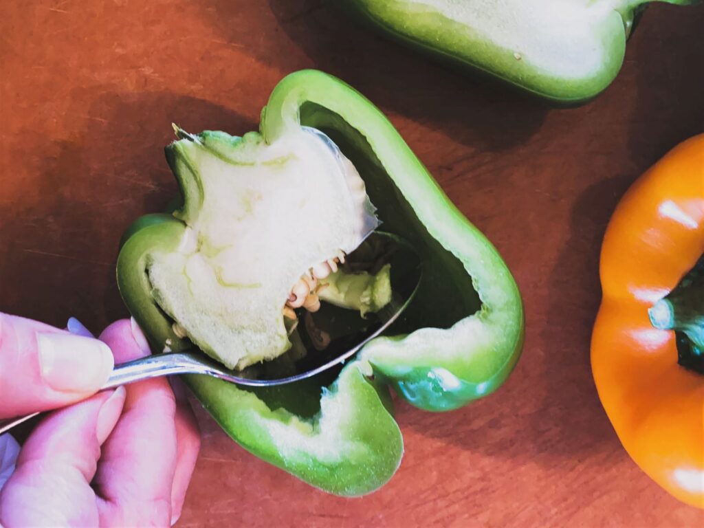 Cleaning bell pepper with a spoon