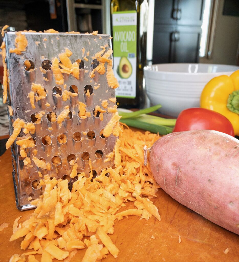Shredded sweet potatoes with metal grater